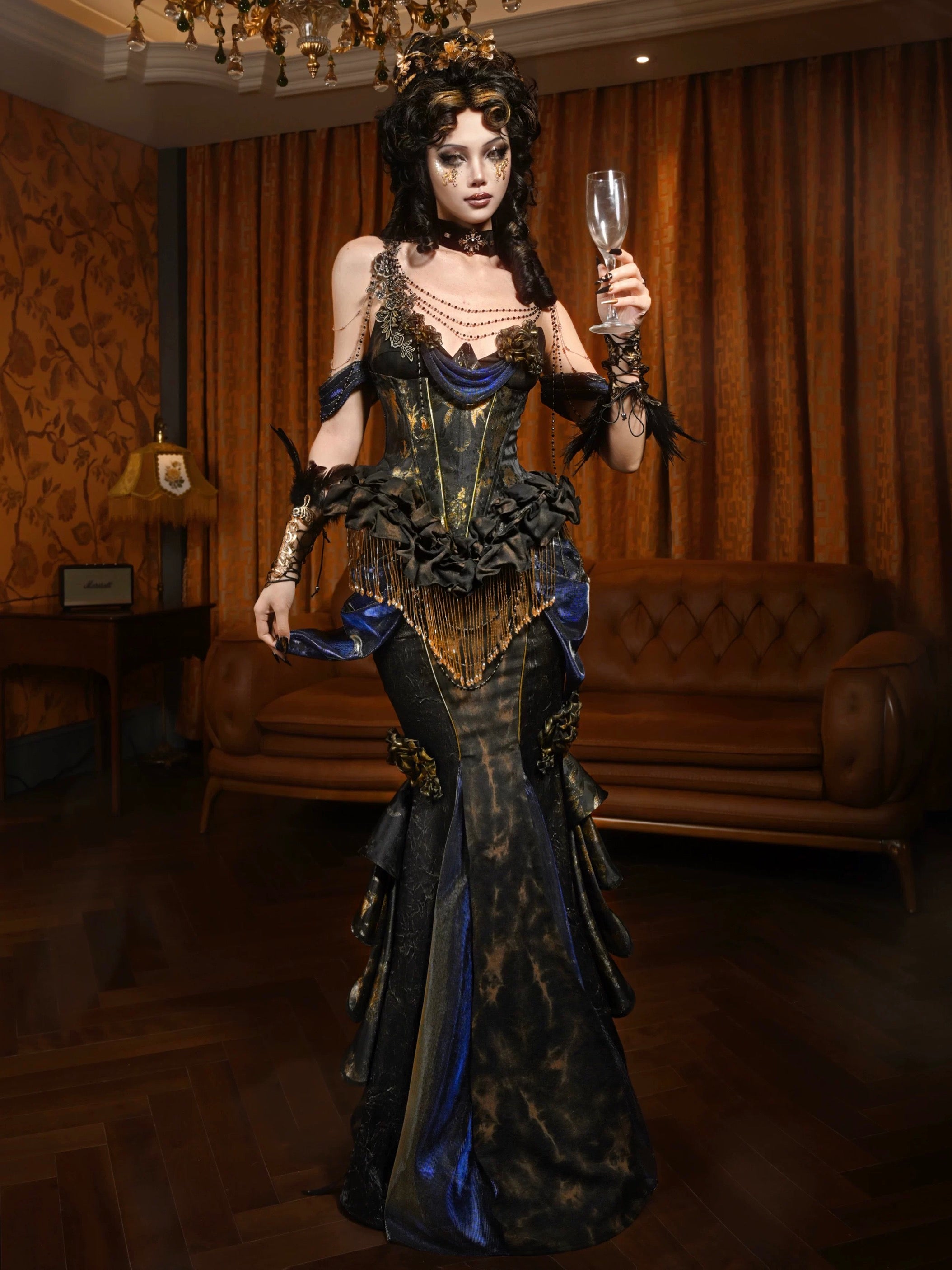 Person in a detailed, ornate dress holding a glass in a dimly lit room.