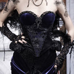 Person wearing a black and purple corset with gothic lace details.