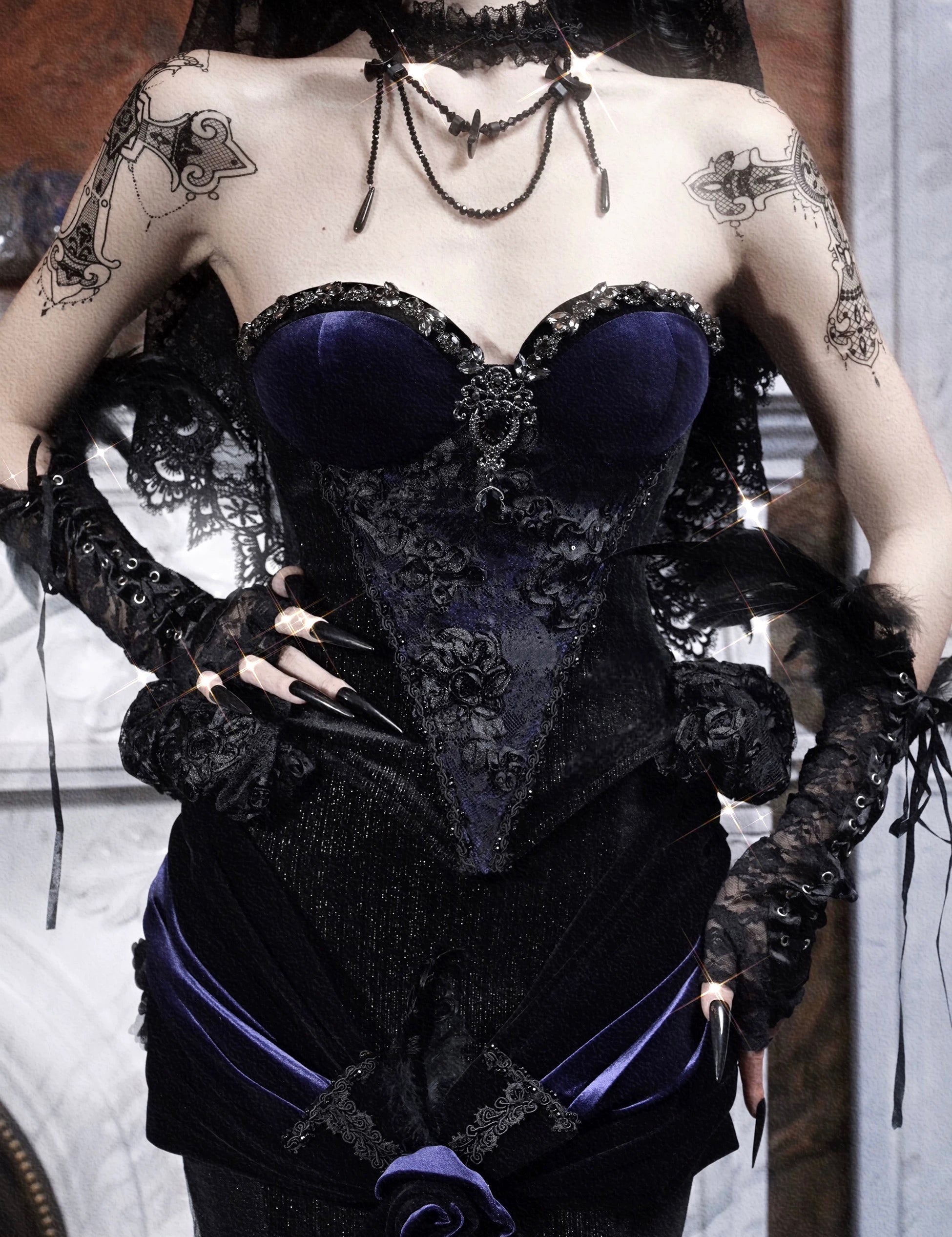 Person wearing a black and purple corset with gothic lace details.