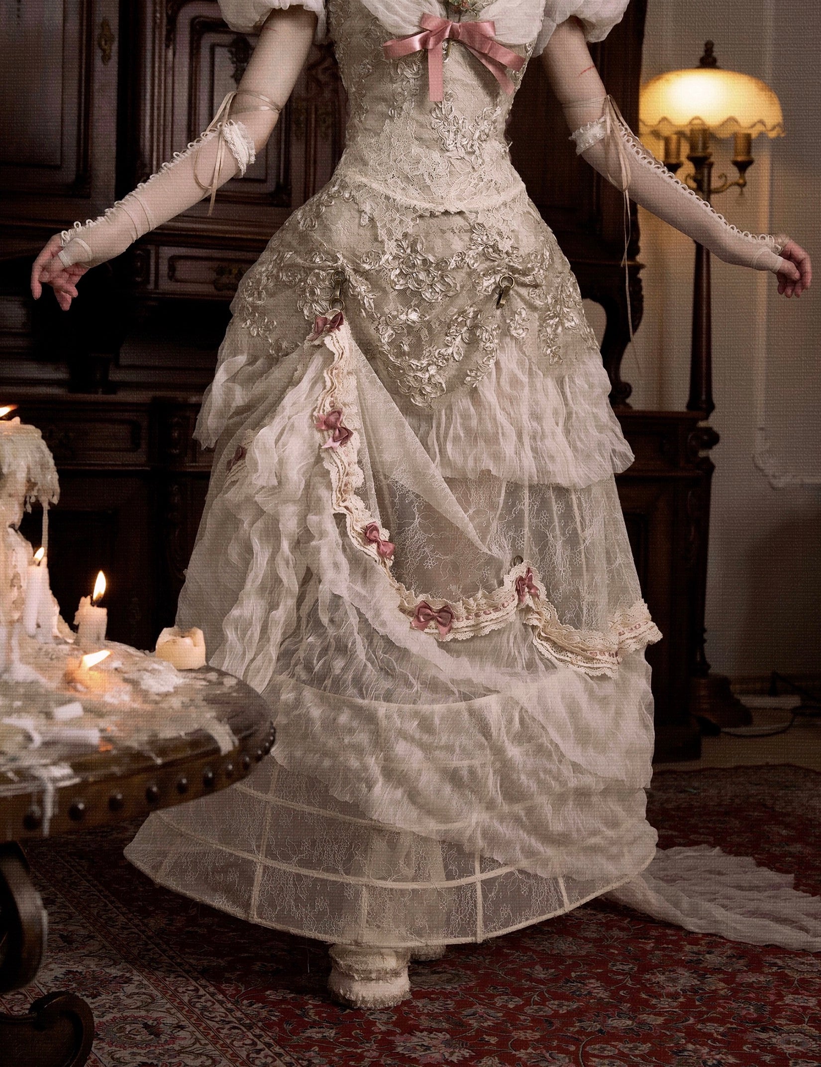 girl wearing a detailed Victorian-era gown in a dimly lit room.