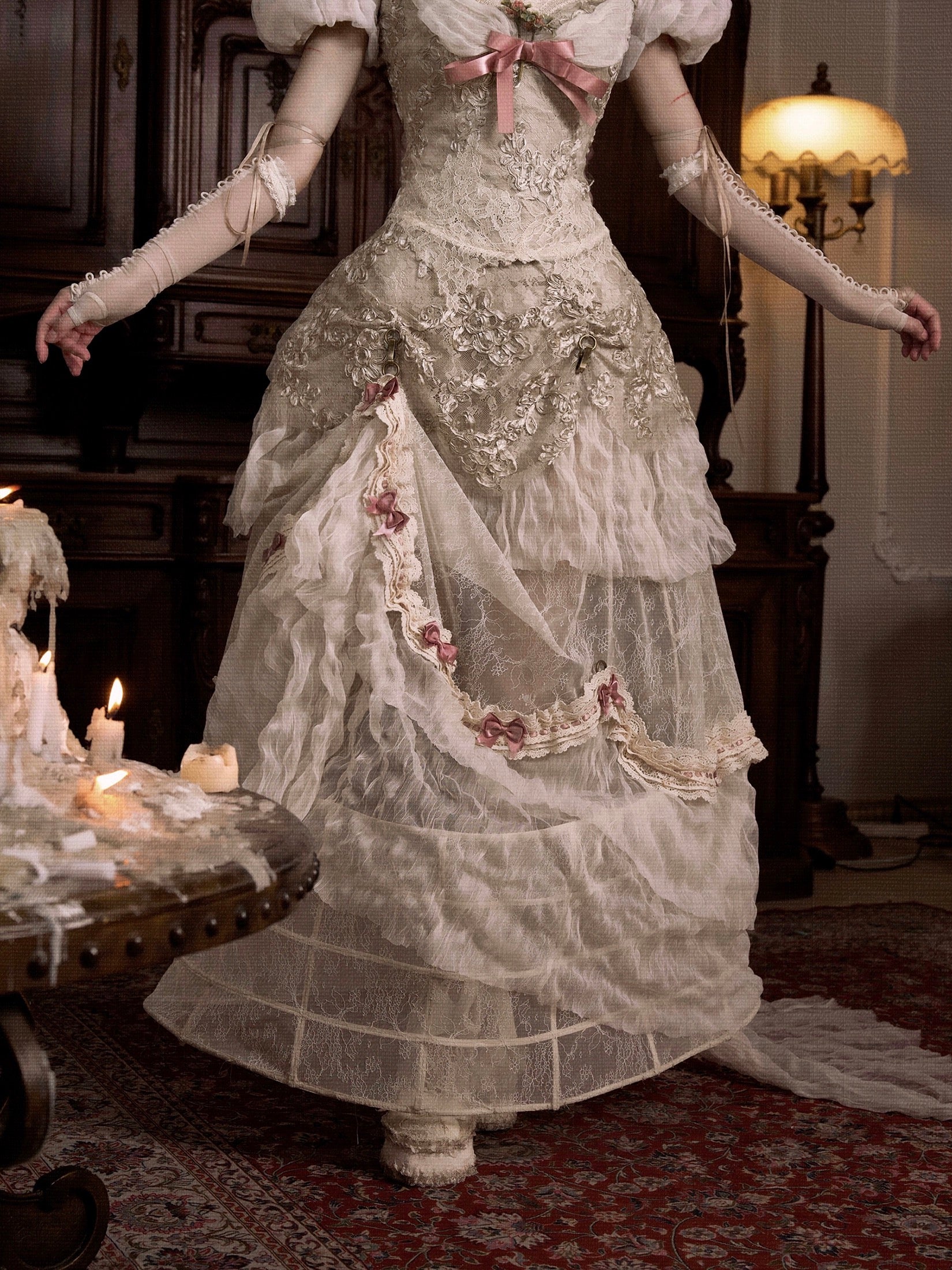 girl wearing a detailed Victorian-era gown in a dimly lit room.