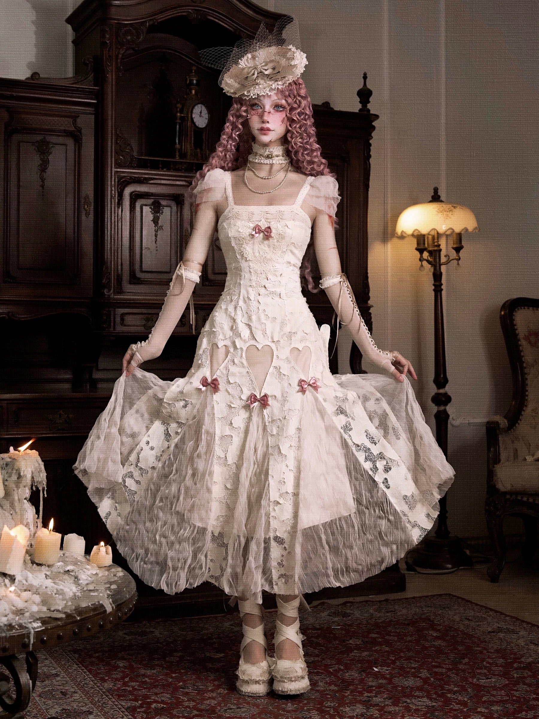 Woman in a detailed vintage white dress with lace and floral patterns in Japanese Gothic Lolita Fashion style.