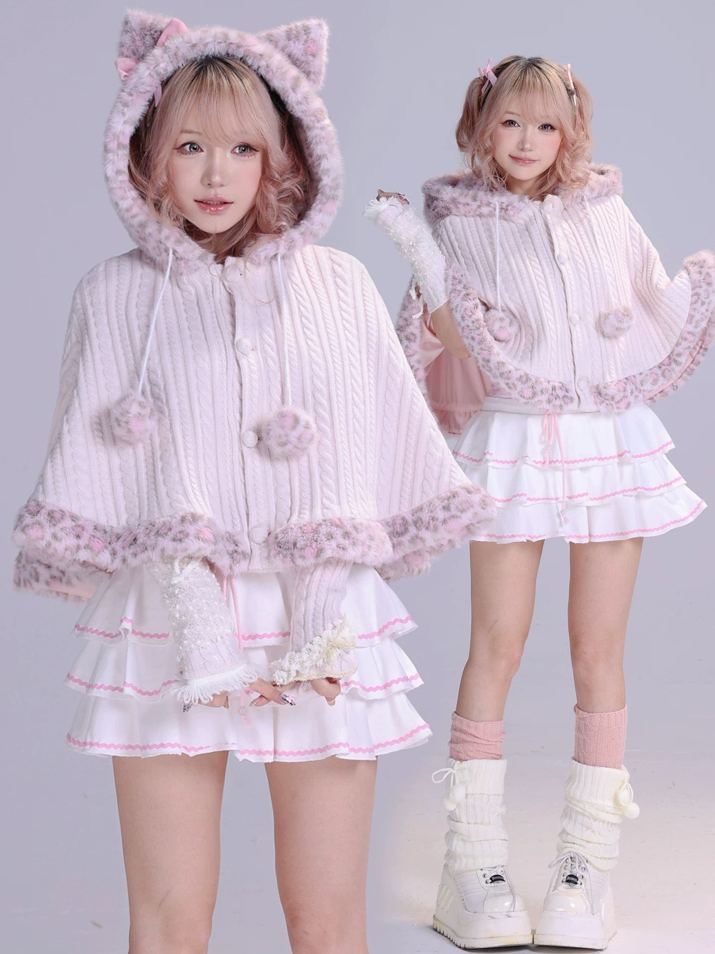 Two girls wearing matching pink and white outfits with cat ears faux fur fluffy cape front view