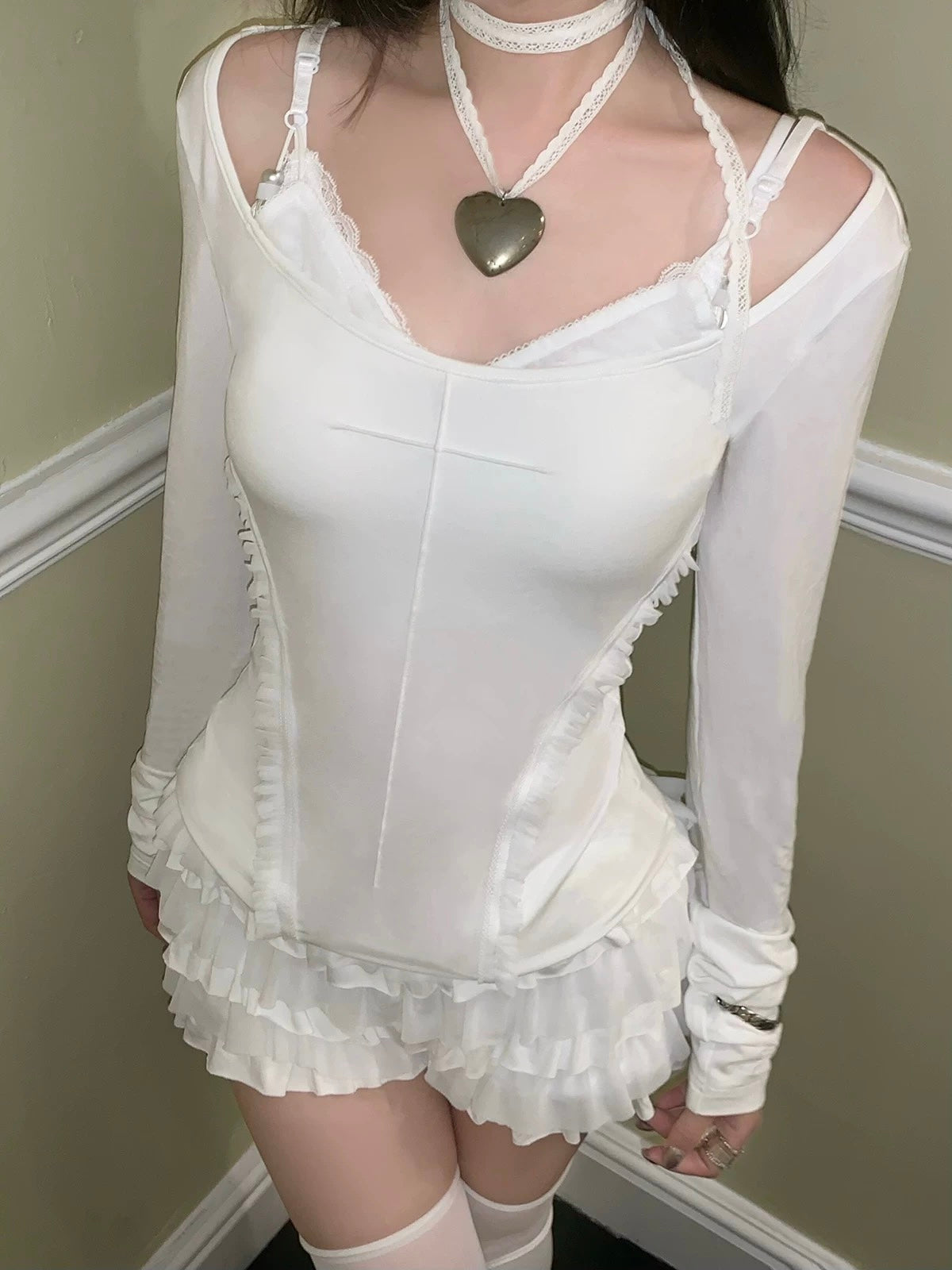 Girl wearing a white lace gothic crop top outfit with a heart-shaped pendant with KittenClaw White Dream Cross Set
