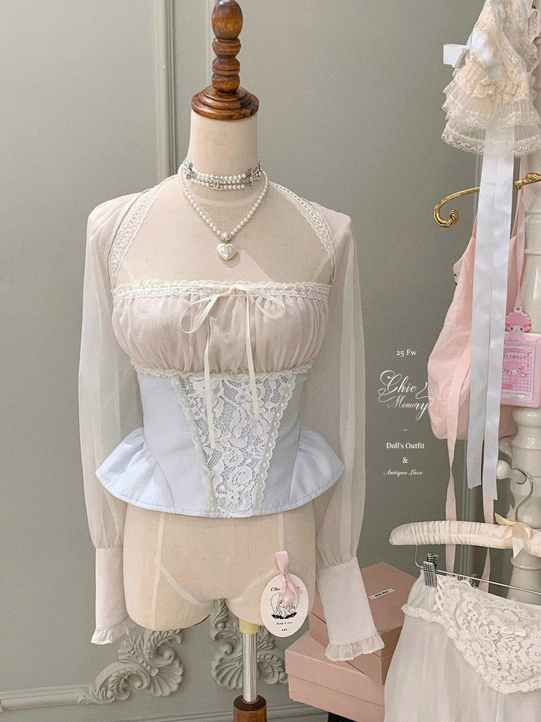 Mannequin wearing a lace top and skirt with sheer sleeves against a neutral background