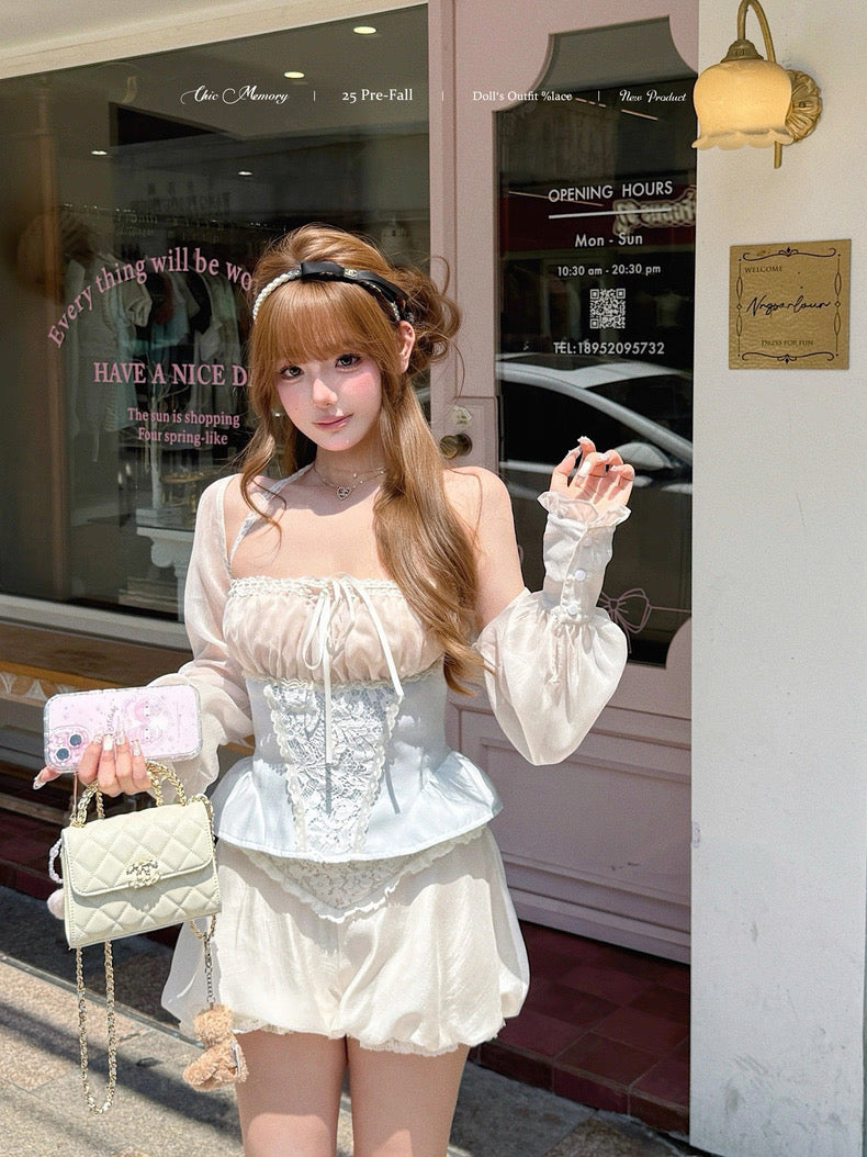 Woman in a white outfit standing outside a store with a pink bag.