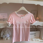 Pink babydoll top with lace details on a hanger against a white background