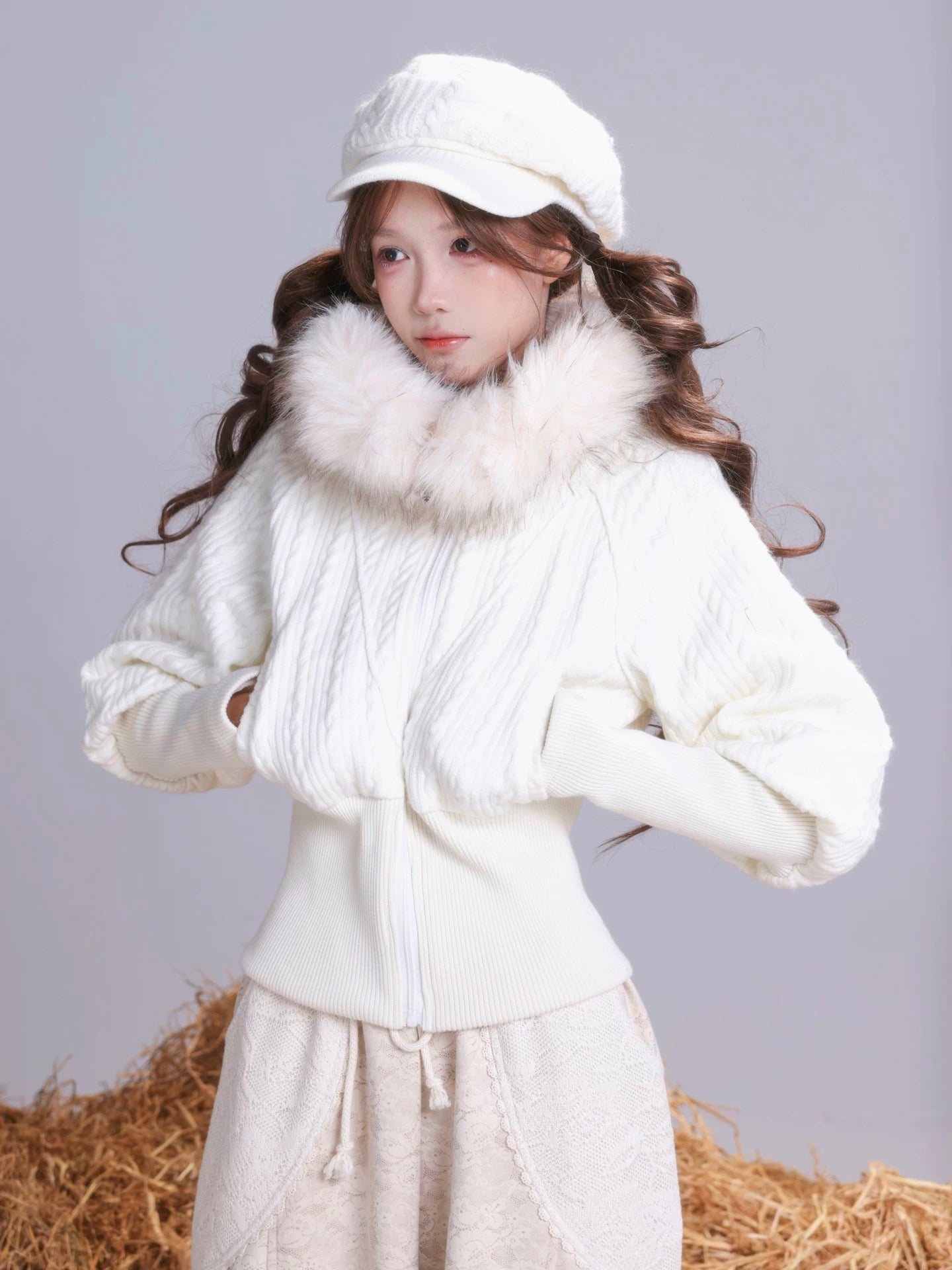 A Girl wearing a white  hoodie outfit with faux fur trim on a plain background