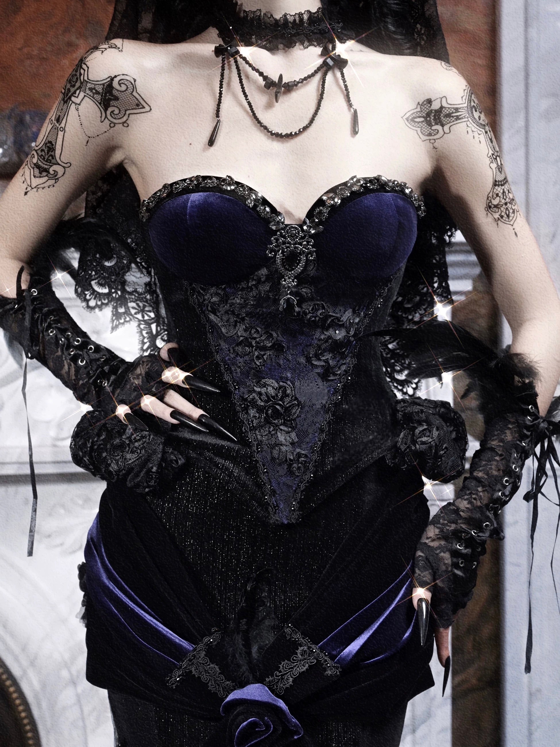 Person wearing a black and purple corset with gothic lace details.