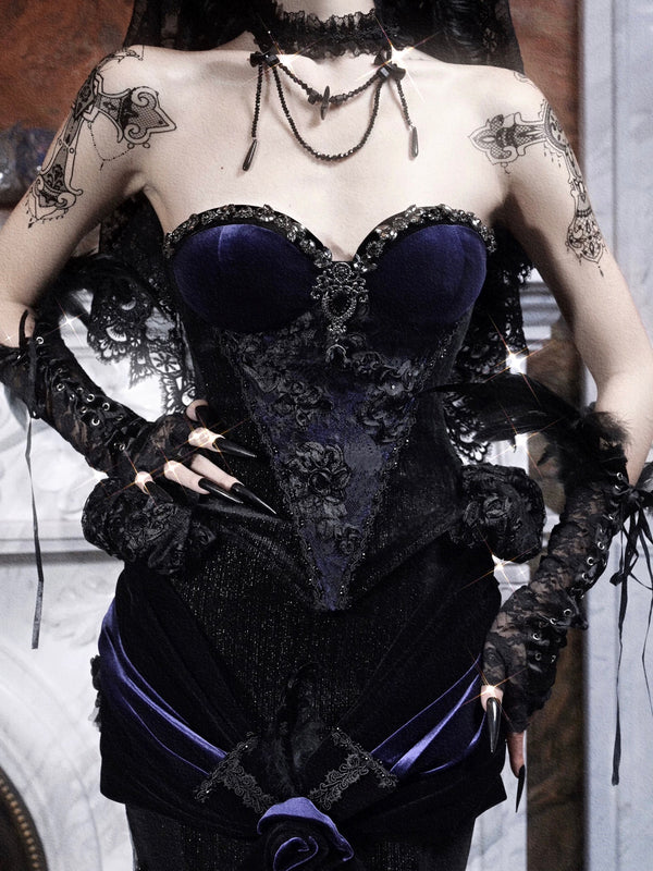 Person wearing a black and purple corset with gothic lace details.