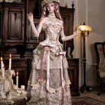 Woman in an elaborate vintage dress with floral details gothic style fashion for halloween custom.