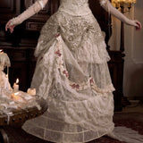 girl wearing a detailed Victorian-era gown in a dimly lit room.