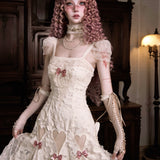 woman in a vintage-style lace white dress with pink ribbon details in a dimly lit room.