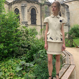 [Pre-order 15% At Checkout] UNOSA Beige Bird & Floral Doll Collar Top and Mini Skirt Set