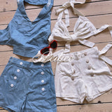Vintage 1997 inspired Blue and white outfits set with buttons on a wooden surface matching heart shaped sunglasses
