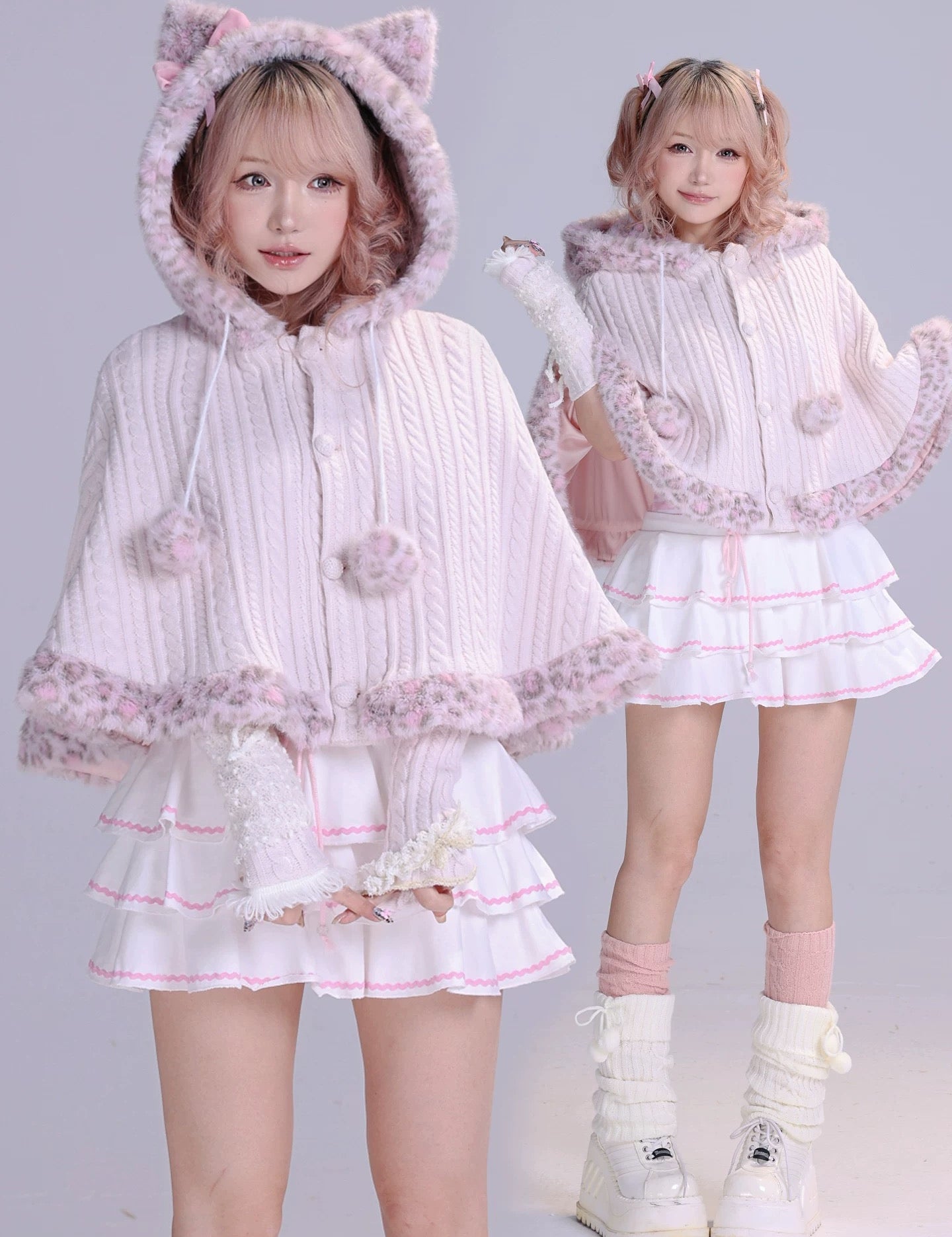 Two girls wearing matching pink and white outfits with cat ears faux fur fluffy cape front view
