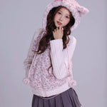 Girl wearing a pink hoodie with cat ears in fluffy faux fur fabric