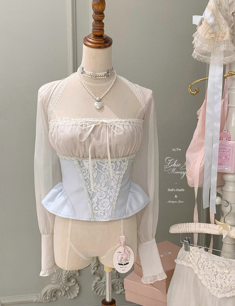 Mannequin wearing a lace top and skirt with sheer sleeves against a neutral background