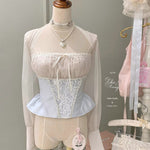 Mannequin wearing a lace top and skirt with sheer sleeves against a neutral background