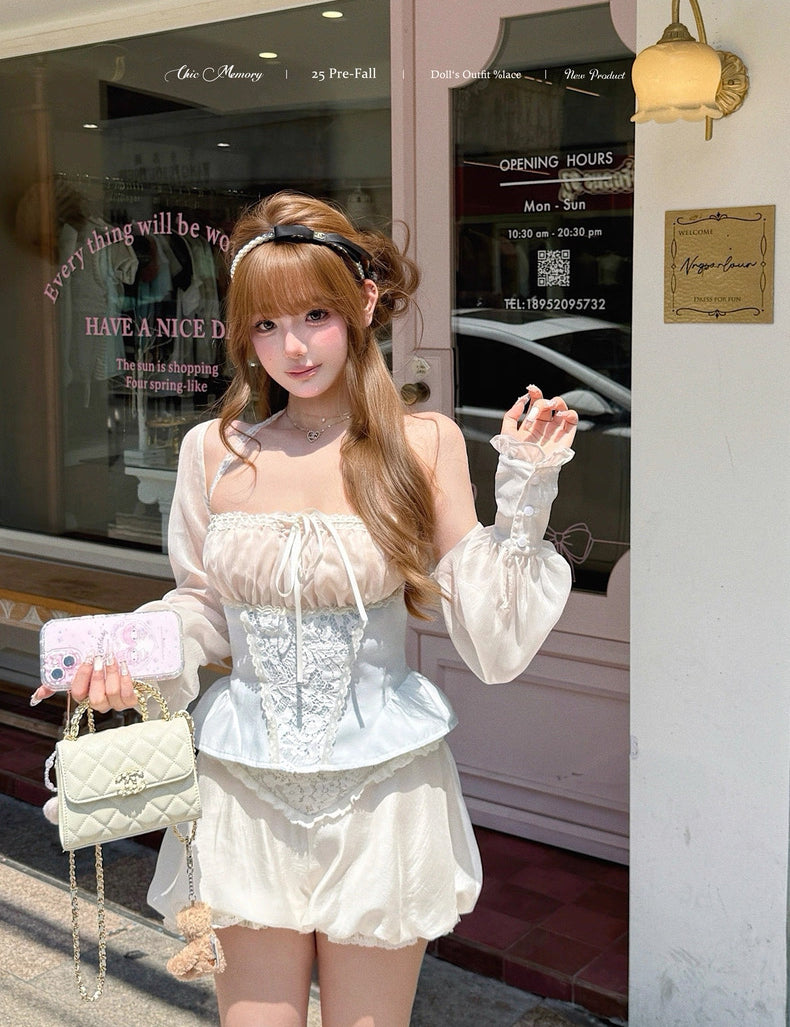 Woman in a white outfit standing outside a store with a pink bag.