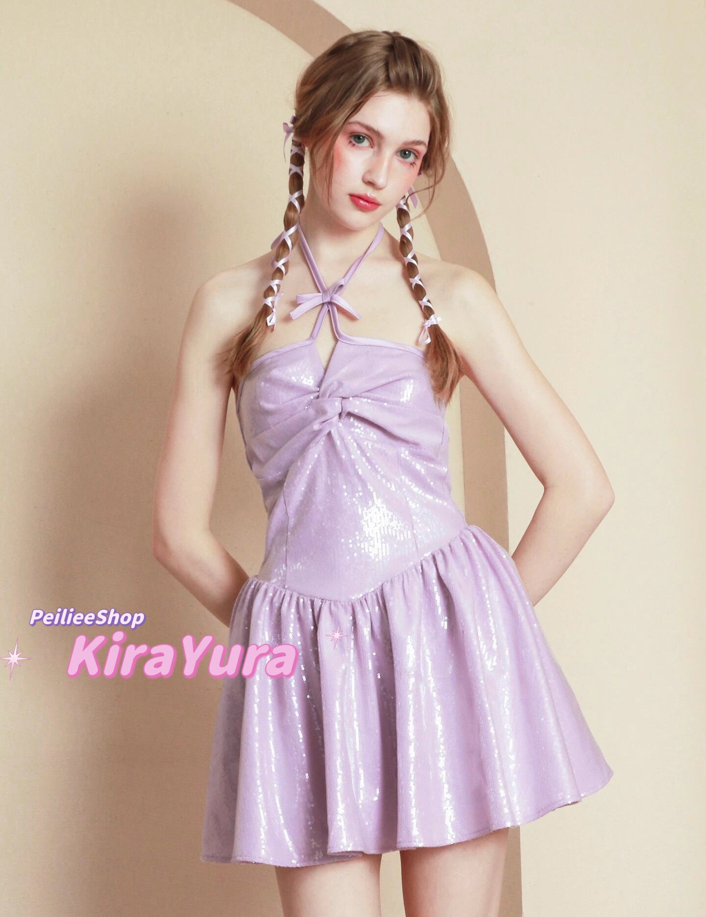 young woman wearing a purple glittery mini dress with a plain background