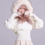 Girl wearing a white  faux fur coat with sheep ears on hood on a gray background
