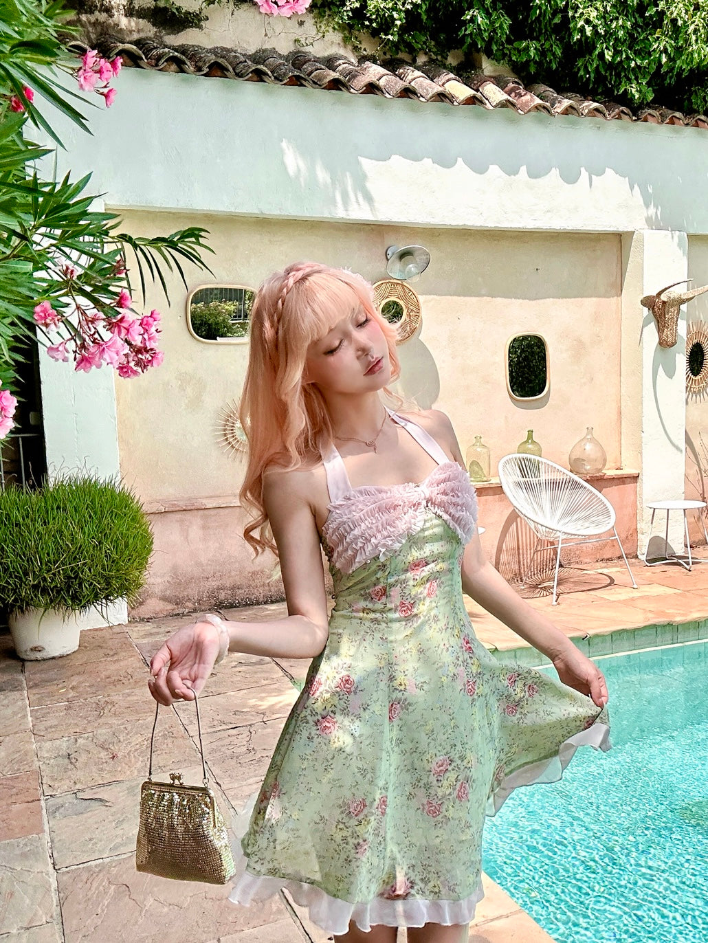 Pink hair girl wearing a floral dress standing by a pool with pastel colors