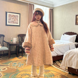 Woman in a deer fawn print plaid dress standing/