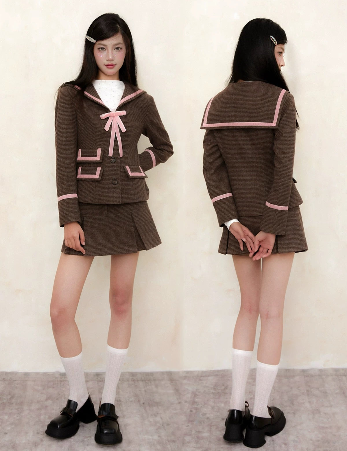 School girl wearing a brown school uniform with pink accents, standing against a plain background.